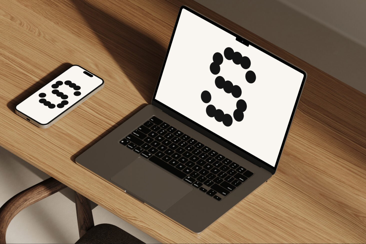 Laptop and smartphone wooden desk mockup with abstract design on screens. Ideal for showcasing digital templates and graphics for designers.