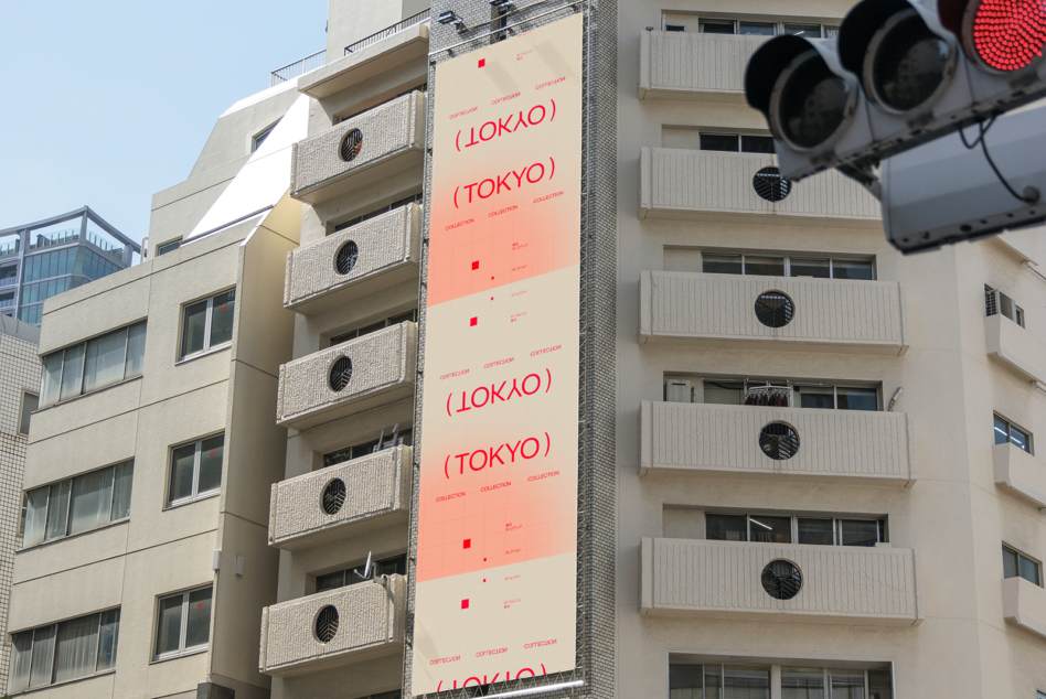 Billboard showing red Tokyo collection text repeating vertically on cream background