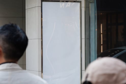 Modern empty vertical billboard mockup on urban street. Perfect for promotional design showcasing in white frame. Ideal for designers and advertisers.
