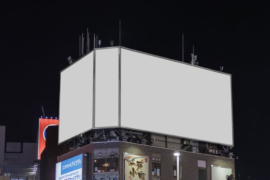 Large rooftop advertising space with empty white surface overlooking brick building