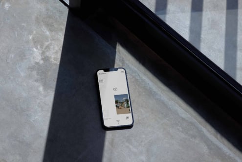 Smartphone mockup on concrete floor with shadow casting modern minimalist design app interface perfect for designers digital assets marketplace templates