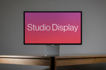 Horizontal desktop monitor on wooden desk showing magenta gradient display