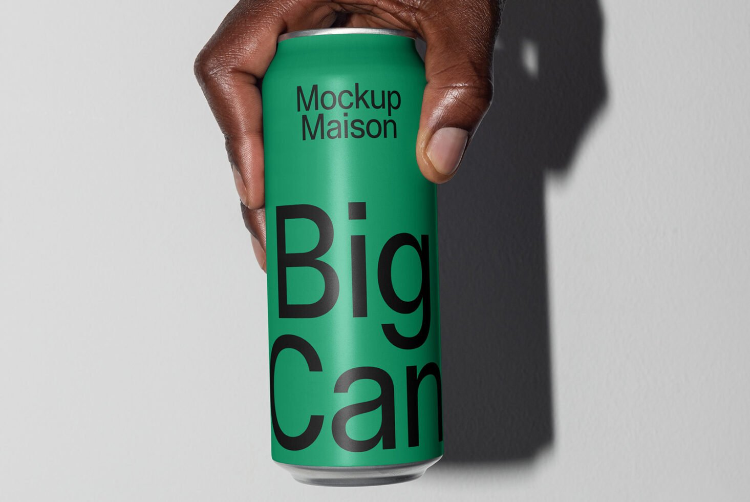 Hand holding a green can mockup with bold black text Big Can ideal for showcasing beverage branding design templates for graphic designers.