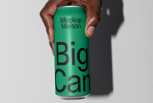 Hand holding a green can mockup with bold black text Big Can ideal for showcasing beverage branding design templates for graphic designers.