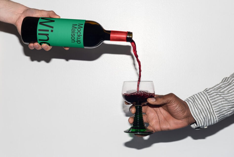 Wine bottle pouring into glass with green label mockup on white background