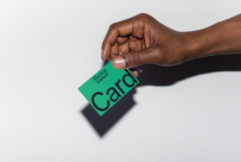 Hand holding business card mockup on white background; ideal for graphic designers seeking customizable branding templates and creatives.