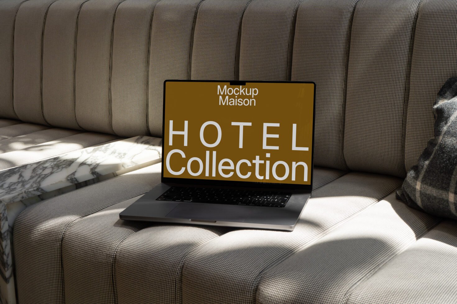 Laptop displaying Hotel Collection mockup on a cushioned sofa with marble table. Keywords: Laptop Mockup Hotel Collection Template Design.