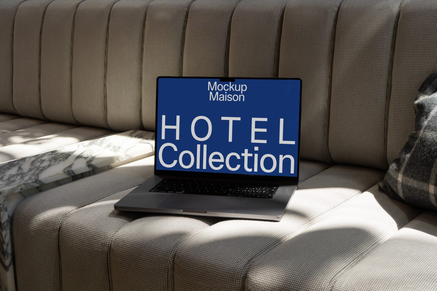 Laptop mockup on a stylish sofa showcasing Hotel Collection. Perfect for designers needing realistic mockups for presentations and branding projects.
