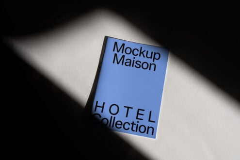 Minimalist booklet mockup with blue cover labeled Mockup Maison Hotel Collection, ideal for designers showcasing print designs, branding concepts.