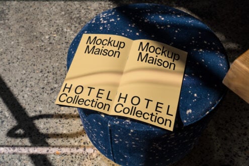 Elegant brochure mockup placed on a stylish blue ottoman with terrazzo floor, ideal for showcasing hotel branding, design templates, and layouts.