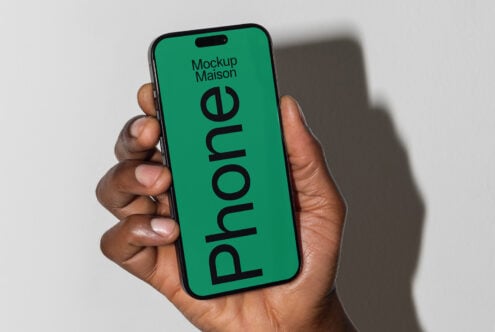 Hand holding modern smartphone with mockup screen, ideal for showcasing design templates and app graphics, perfect for designers seeking mockups.