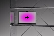 Laptop on minimalist shelf with modern geometric background featuring digital graphic mockup in vibrant pink ideal for design templates and presentations.