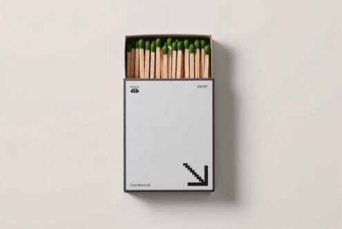 Minimalist matchbox mockup with green-tipped matches in open box. Ideal for branding presentations, packaging designs, graphic projects.