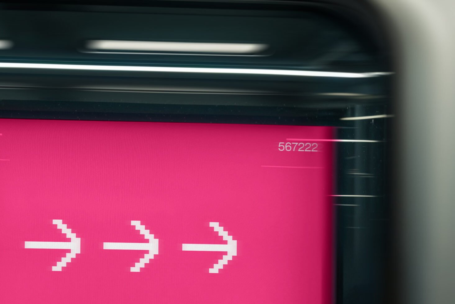 Pink digital display featuring pixelated white arrows; futuristic design element for graphic templates, modern mockup background, tech-inspired visual.