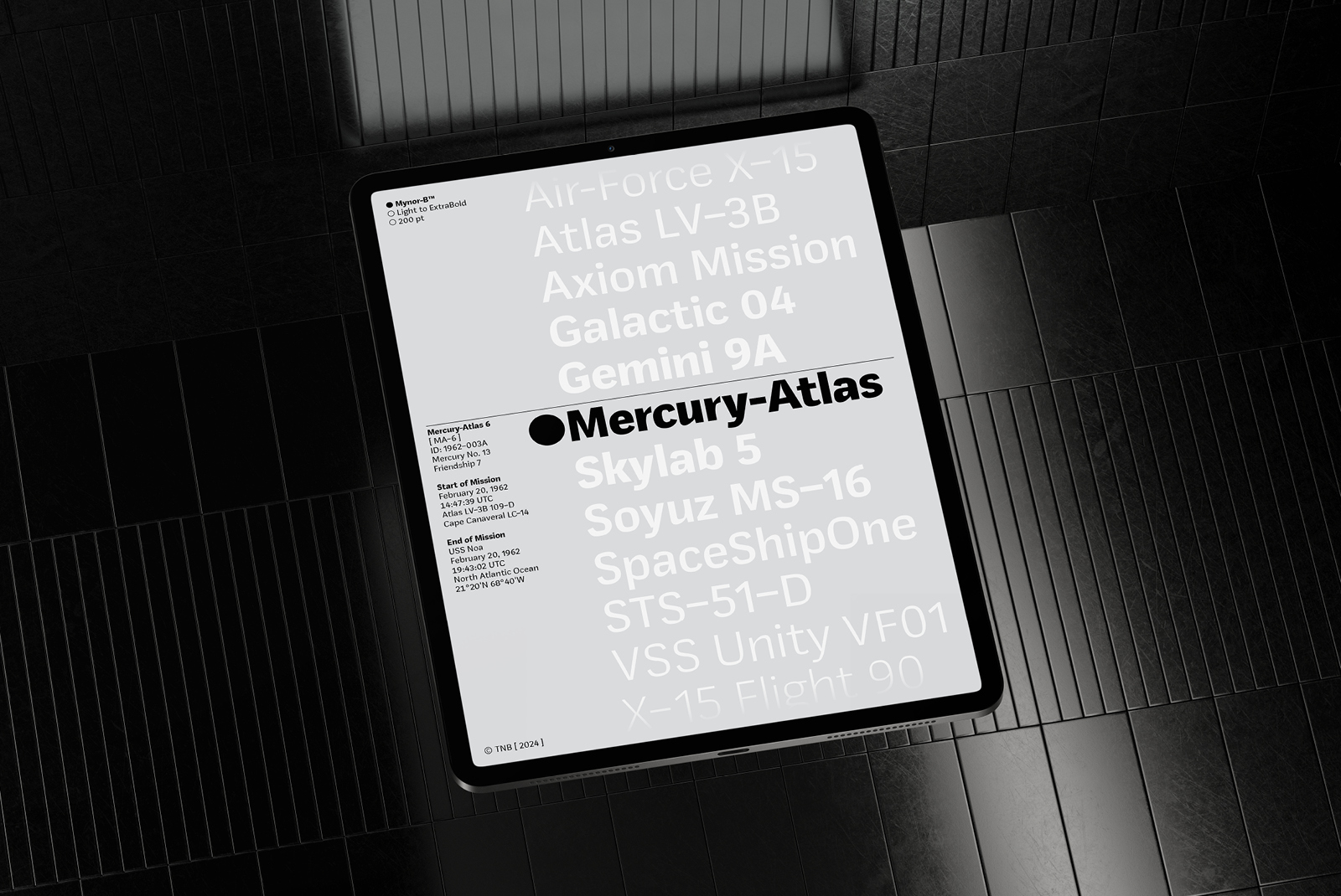 Tablet on tiled floor displaying a modern sans-serif font sample named Myron in various weights light to extra bold with mission-themed text.