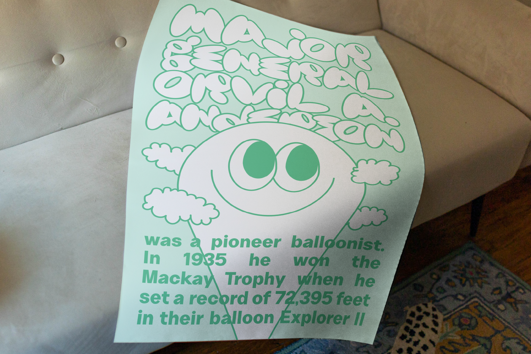 Fun retro-style poster on couch with playful typography featuring a smiling balloon character with inspirational text ideal for posters graphics designers.