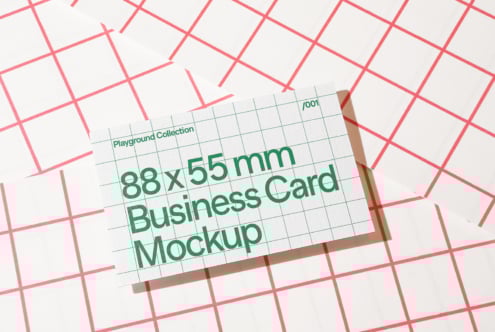 Business card mockup 88x55 mm on gridded pink paper background. Ideal for designers seeking modern templates. Professional graphic asset for branding.
