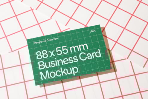 Business card mockup with green grid design on red checkered background. Ideal for designers needing a realistic template for showcasing card designs.