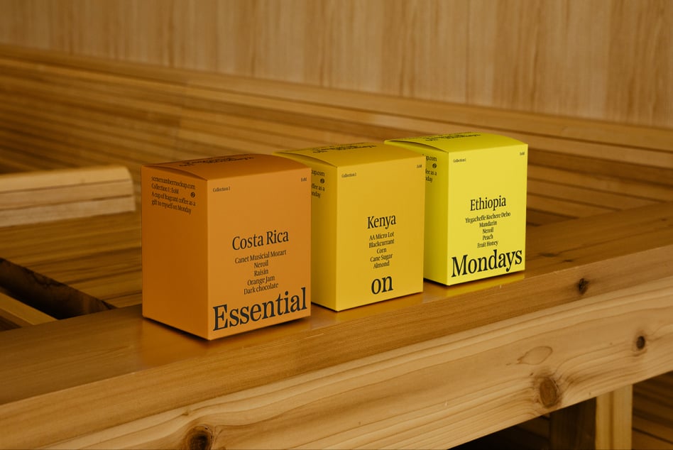 Three colorful coffee packaging boxes labeled Costa Rica Kenya Ethiopia on a wooden shelf showcasing typography design ideal for mockups and branding projects