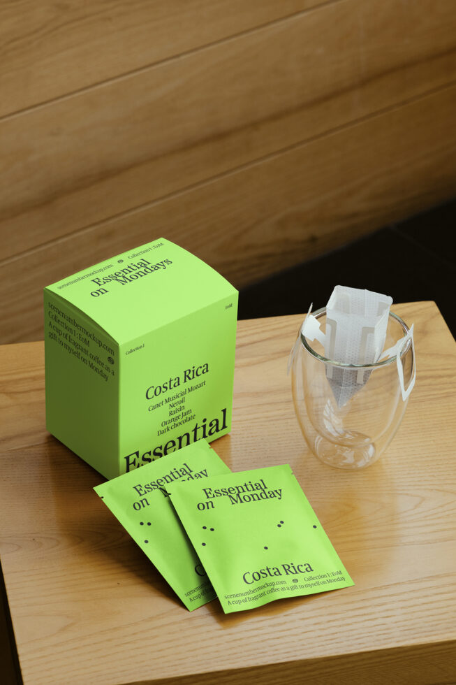 Bright green coffee packaging mockup featuring Essential Mondays branding, Costa Rica theme. Includes box, sachets, drip filter. Ideal for designers.