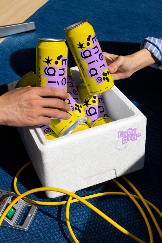 Energia energy drink can mockup on blue carpet two hands reaching into foam cooler graphic design template vibrant yellow purple packaging SEO