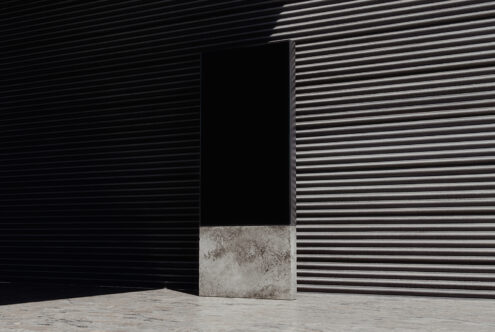 Minimalist poster mockup with a concrete base against a corrugated metal wall ideal for branding presentations urban design templates SEO friendly