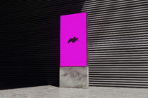 Digital display mockup in an industrial setting with bold magenta backdrop perfect for design presentations or mockups. Ideal for graphic designers.