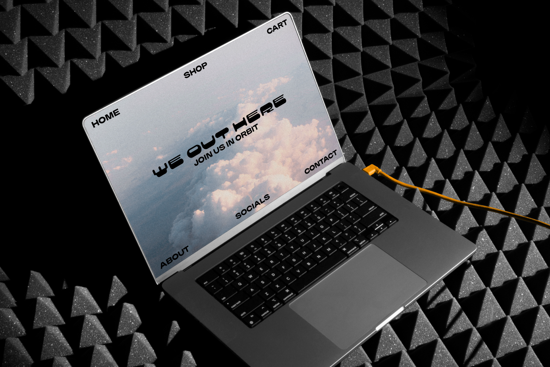 Laptop with open screen showing website mockup design on geometric patterned background perfect for designers focused on templates and graphics.
