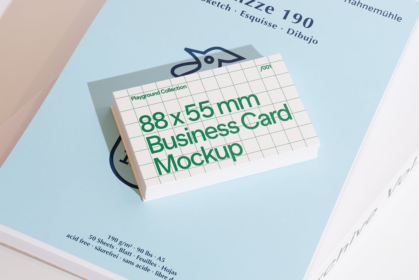 Green business card mockup displayed on light blue paper background
