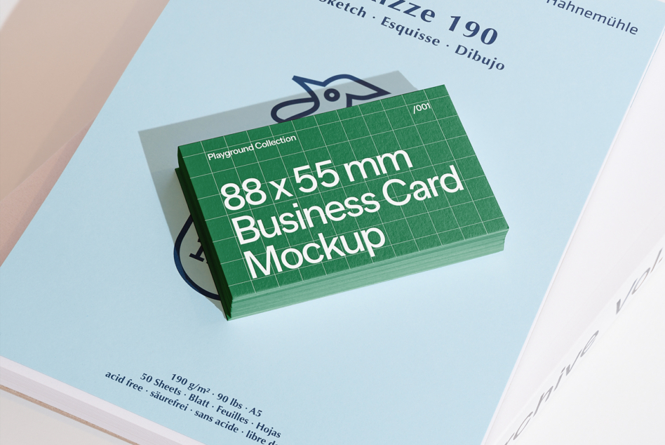 Business card mockup stacked on light blue paper with design label