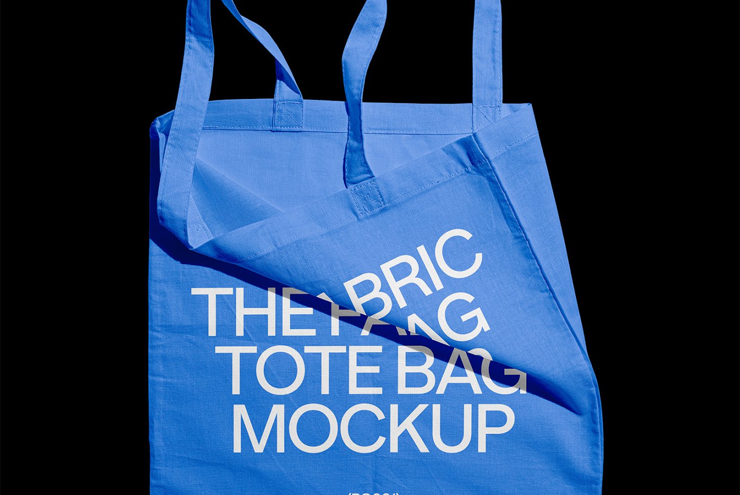 Blue fabric tote bag mockup with white text isolated on black background for designers. Perfect for showcasing custom designs and branding.
