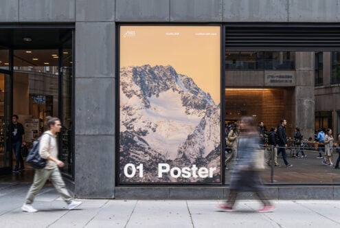 Street view with large poster mockup on building facade featuring snow-covered mountains ideal for graphic designers looking for realistic display templates.