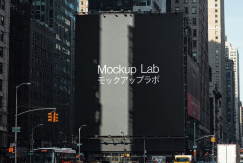 Urban street scene with large building billboard mockup featuring Mockup Lab text ideal for designers looking for professional graphic templates