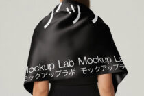 Black cape with white stripe pattern worn as shoulder garment