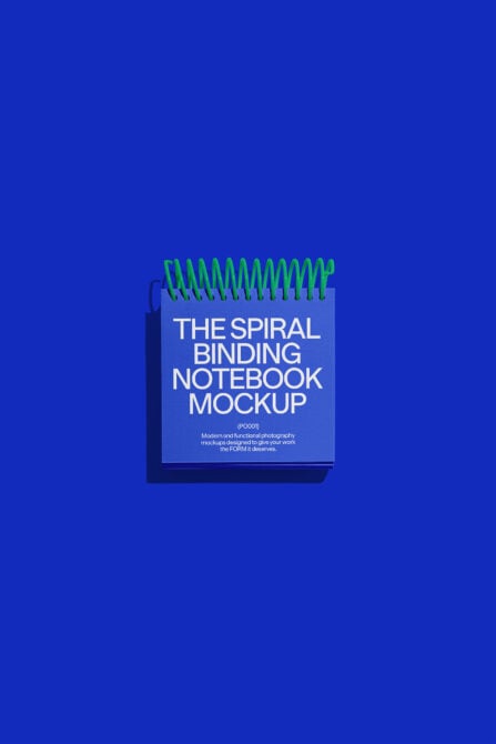 Spiral binding notebook mockup with blue cover on a vibrant blue background ideal for graphic designers and template creators high-quality design resource.