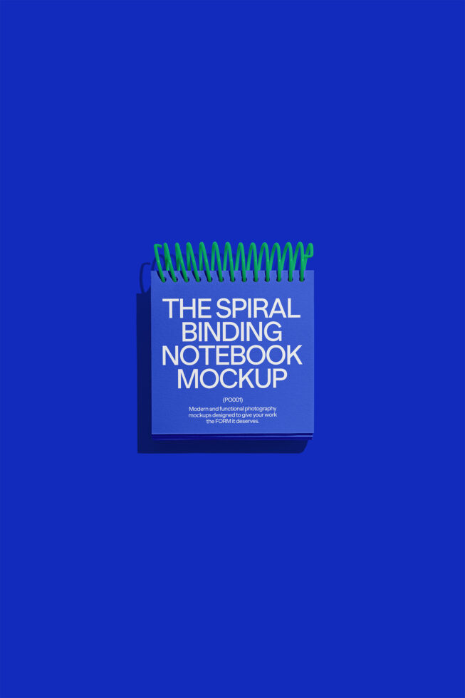 Spiral binding notebook mockup with blue cover on a vibrant blue background ideal for graphic designers and template creators high-quality design resource.