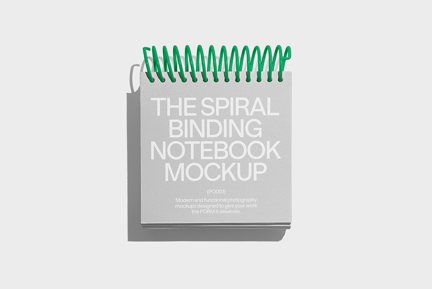 Spiral binding notebook mockup on white background with green rings ideal for designers template layouts and graphic design presentations.