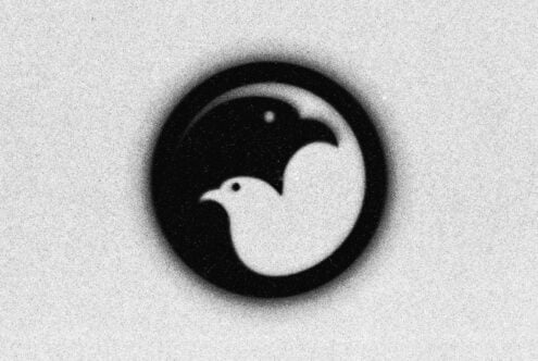 Yin yang symbol in black with soft blur effect on grainy background