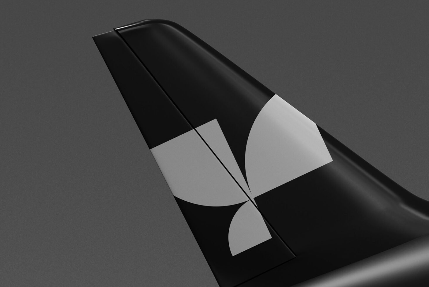 Black airplane tail with modern abstract geometric logo design on a dark grey background perfect for branding mockup and graphic design projects.