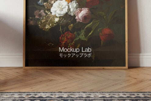 Framed floral art mockup with elegant flowers in wooden frame on herringbone floor for design presentation suitable for graphic designers and artists.