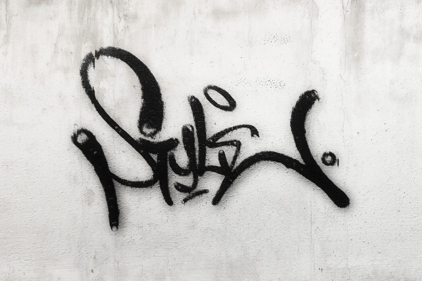 Graffiti font on a white concrete wall showcasing urban street art style. Perfect for graphic designers seeking edgy and creative font inspiration.