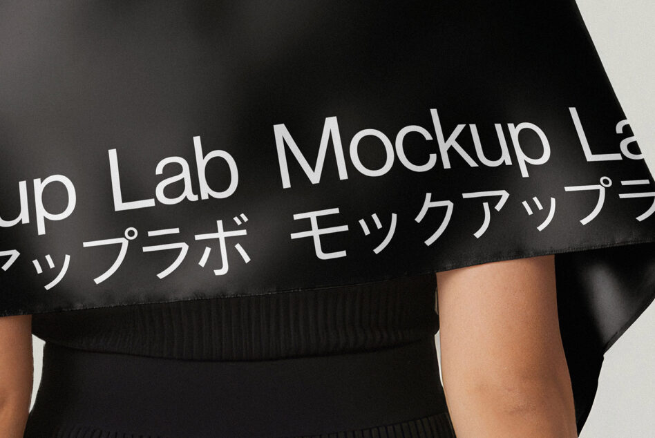 Black oversized fabric with white text draped across shoulders