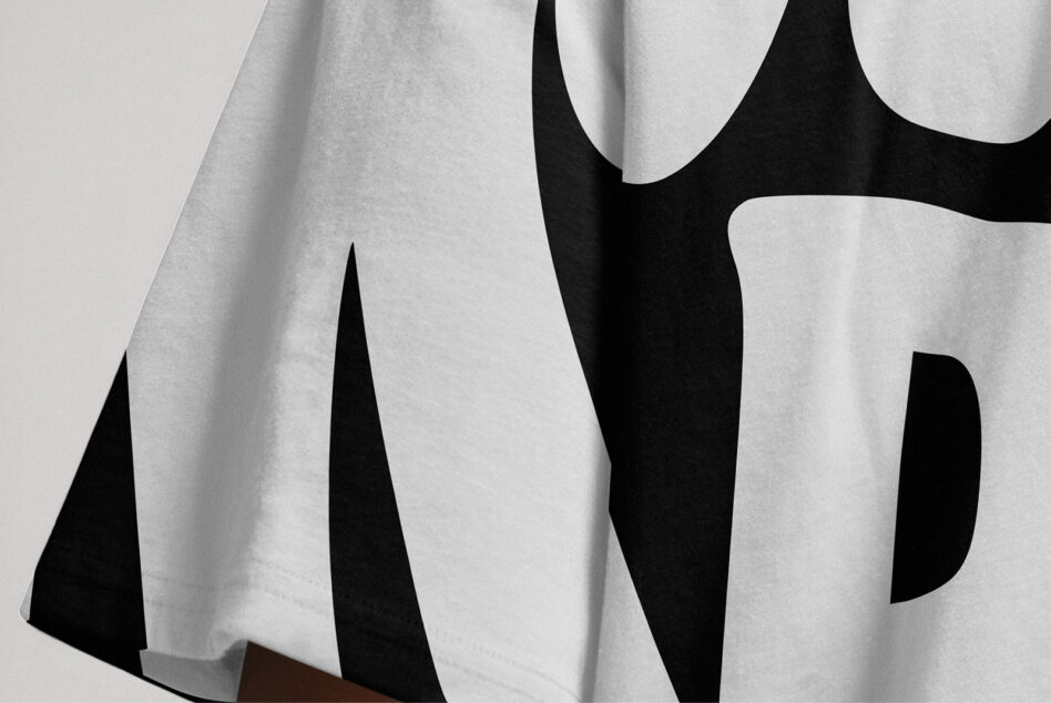 Close up of folded fabric with black swooping cutouts on white material