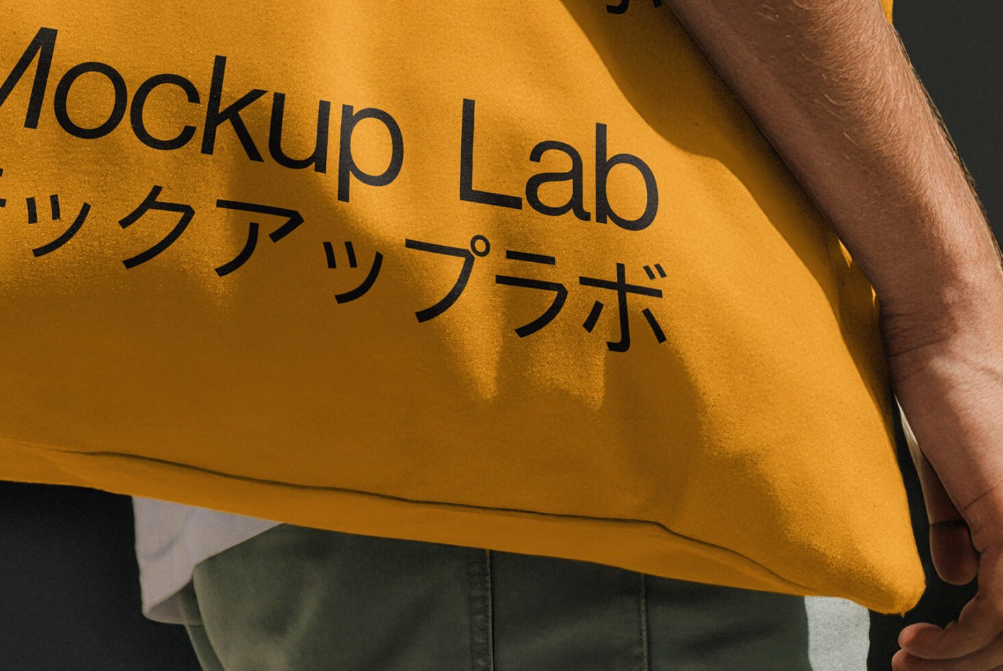 Yellow tote bag mockup with bold black text in English and Japanese. Ideal for showcasing design templates and branding concepts for creative designers.