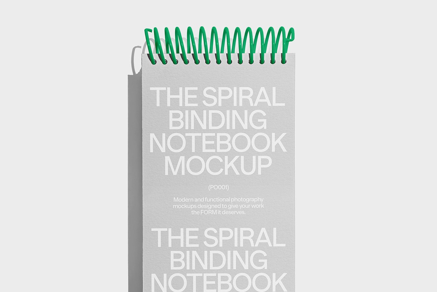 Spiral binding notebook mockup with green coils on gray background ideal for designers creating realistic stationery presentations and graphic design projects