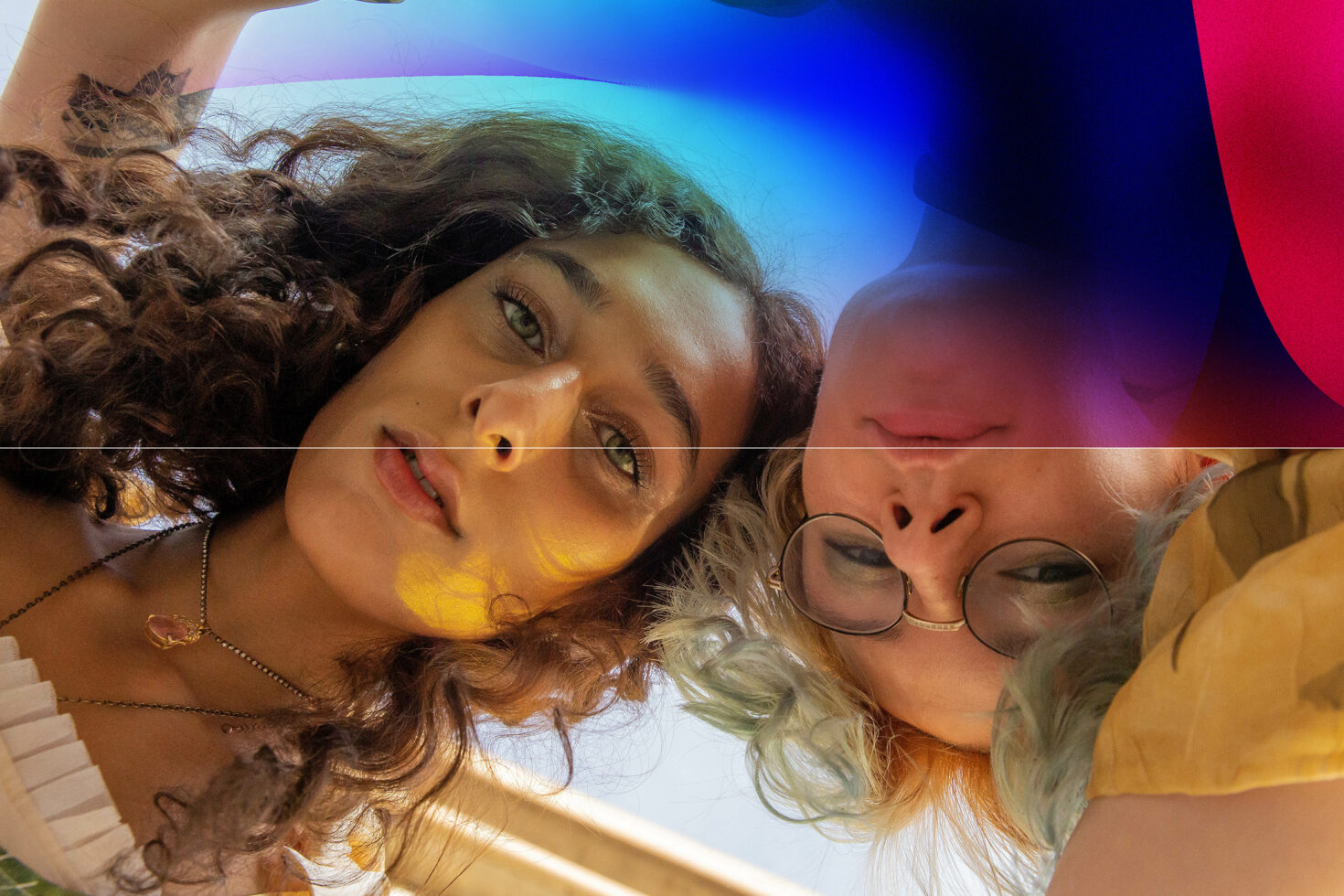 Creative portrait of two women from below with vibrant abstract overlay; perfect for graphic designers and digital art concepts.