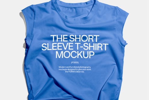 Blue short sleeve t-shirt mockup displayed on flat surface. Ideal for showcasing designs. High-quality apparel template for graphic designers.