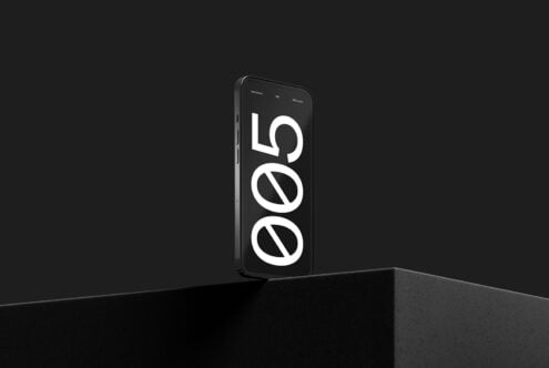 Black phone displaying large white geometric shapes on screen mockup
