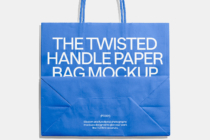 Blue paper shopping bag with twisted handles on light background with shadow