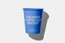 Blue paper cup mockup casting shadow on light gray background